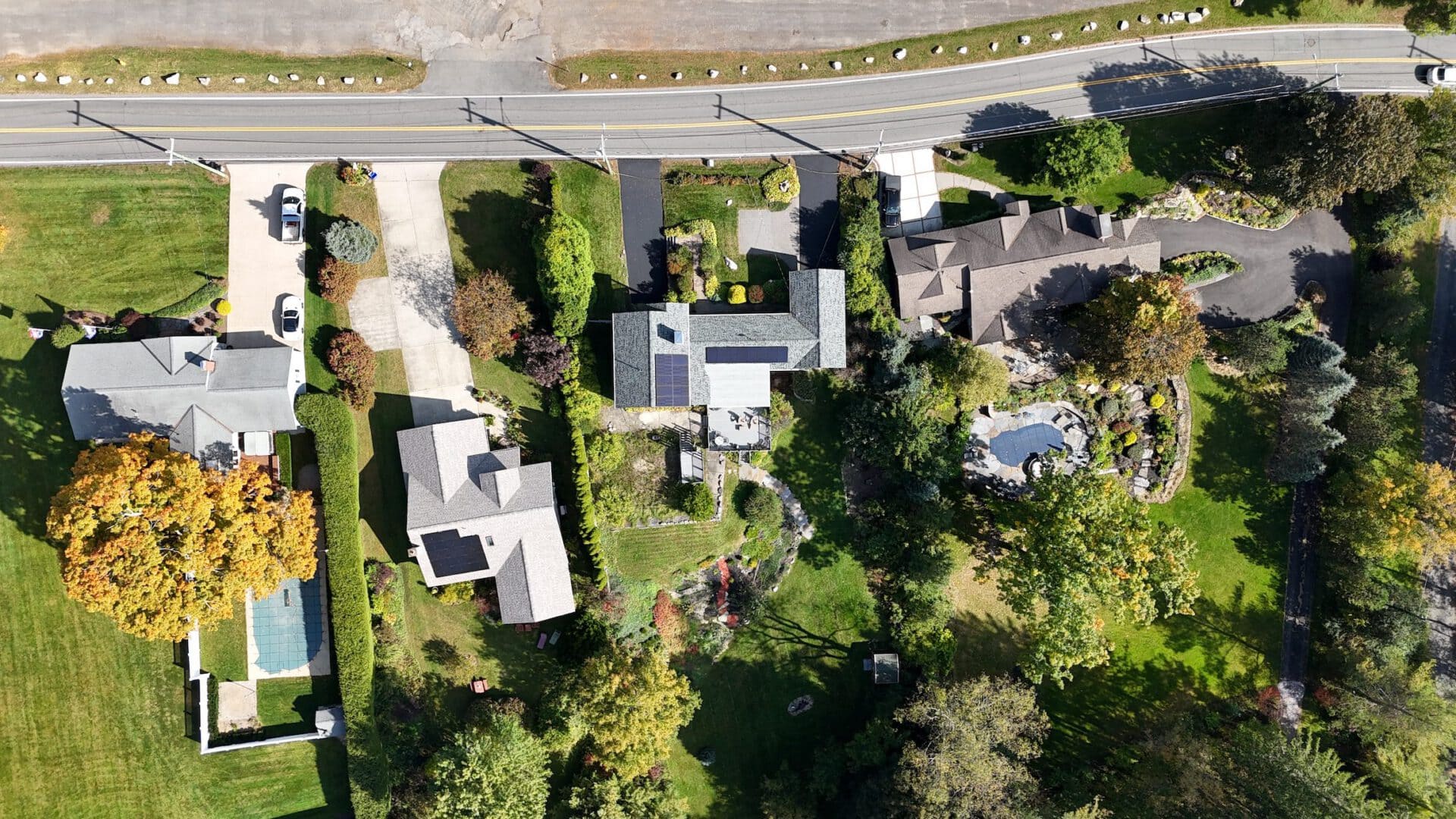 Solar panels installed on rooftops of residential homes in a suburban neighborhood.