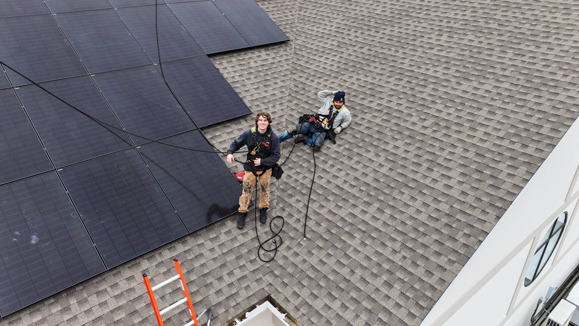 Solar panel cleaning technicians on rooftop installing and maintaining solar energy systems in Valley Solar project.