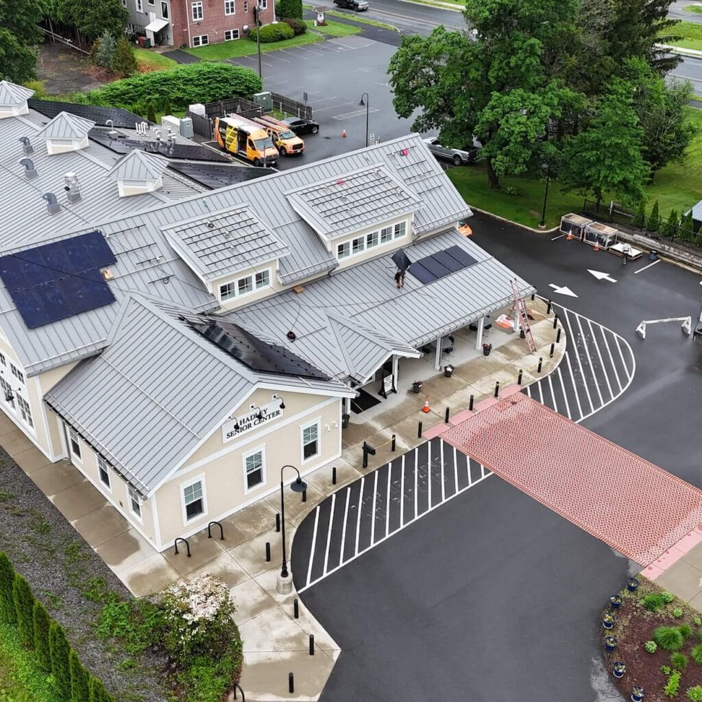 Solar panel installation on commercial building roof, Valley Solar solar energy solutions, rooftop solar system for community center.