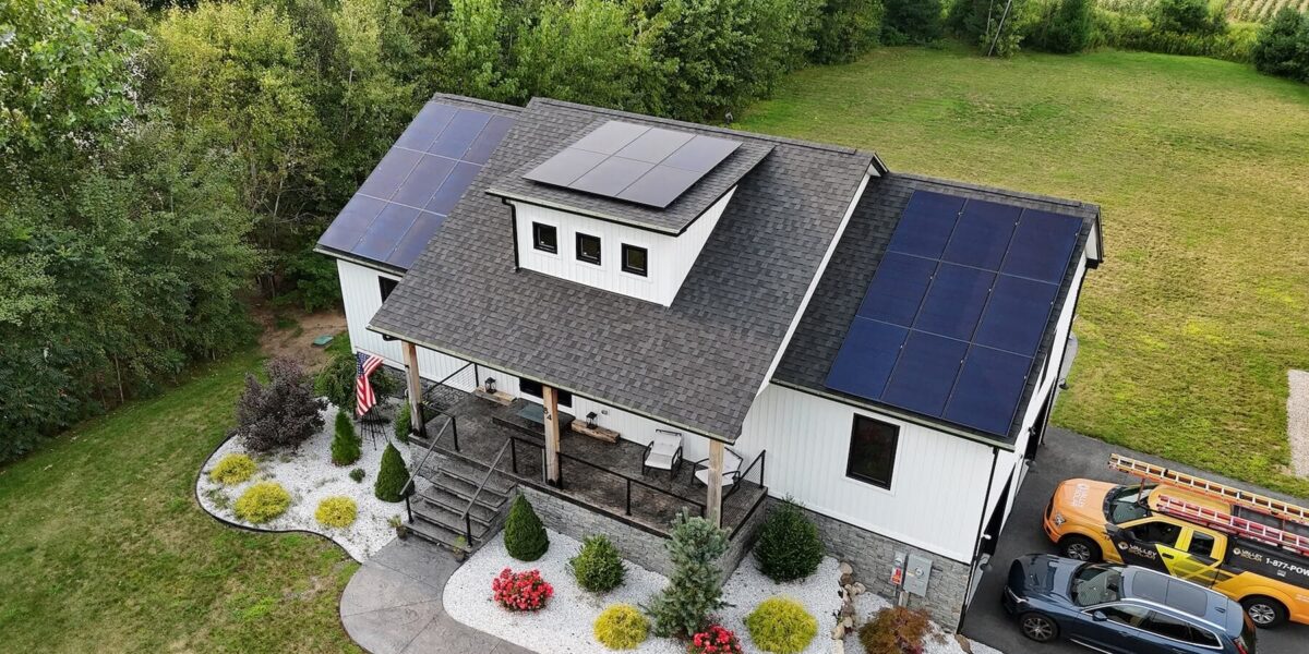 Solar panels installed on the roof of a modern farmhouse, showcasing renewable energy solutions for homes.