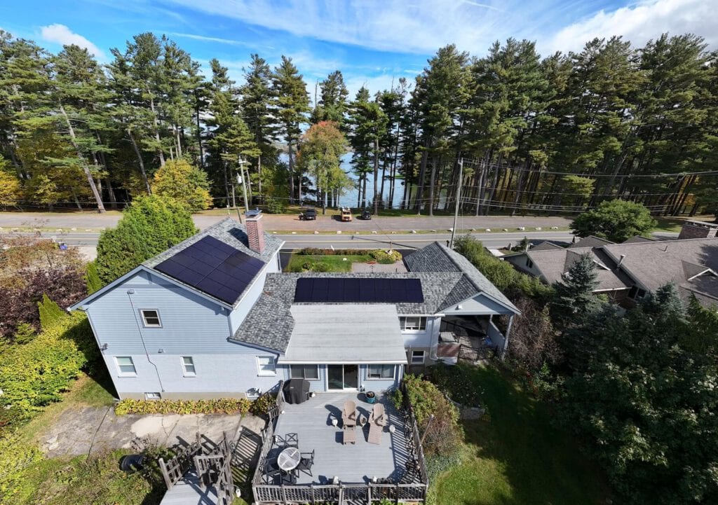 Solar panel system on residential roof in valley setting, energy-efficient, eco-friendly home, renewable energy, solar power, sustainable living.