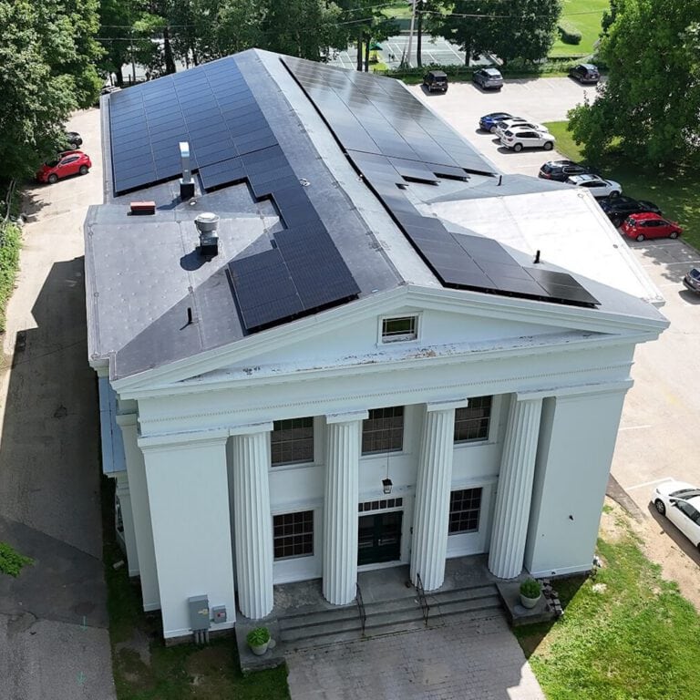 Solar panels installation on a historic building roof for renewable energy.
