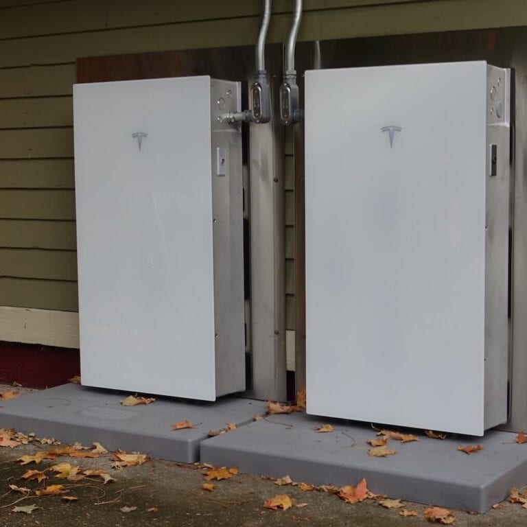 Electric vehicle charging station with Tesla chargers installed outdoors.
