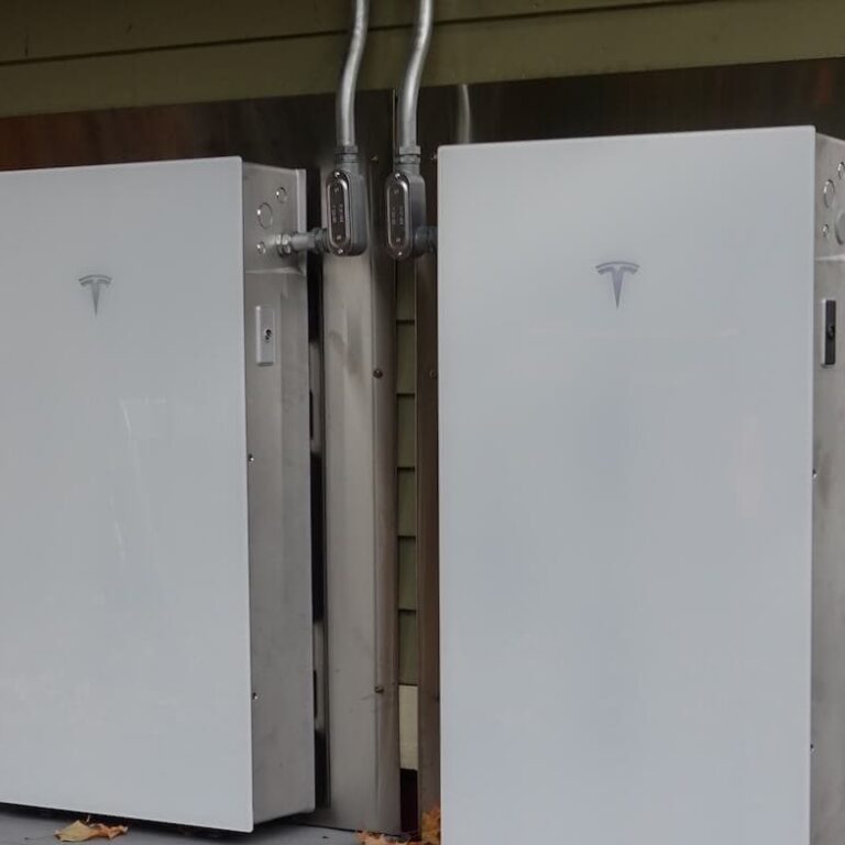 Electric vehicle charging station with Tesla chargers installed outdoors.