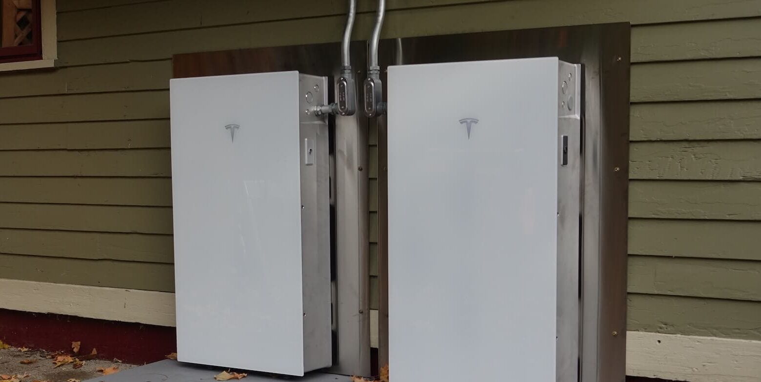 Electric vehicle charging station with Tesla chargers installed outdoors.