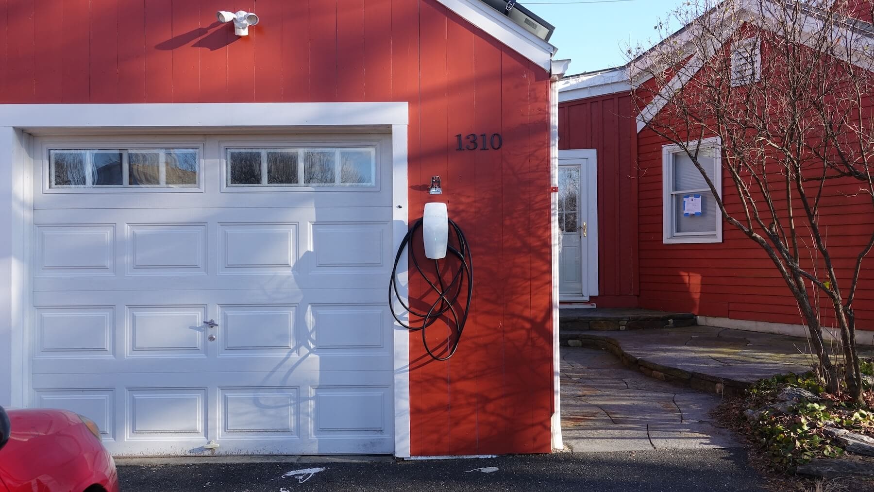 Solar-powered electric vehicle charging station on the house exterior, energy-efficient home, Valley Solar.