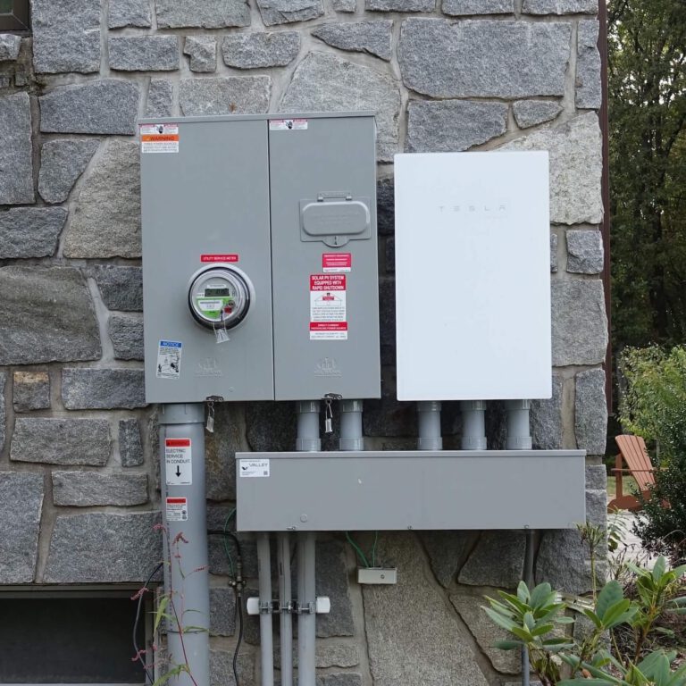 High-efficiency solar power system and Tesla energy inverter installed outdoors.